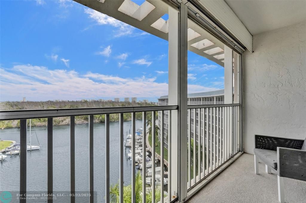 1523 East Hillsboro Boulevard, Unit 1031 Deerfield Beach, FL 33441 - Photo 41 of 78 a view of a balcony with wooden fence and floor