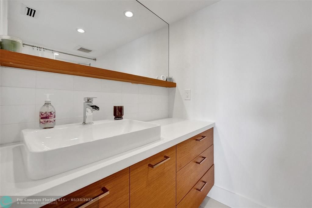 1523 East Hillsboro Boulevard, Unit 1031 Deerfield Beach, FL 33441 - Photo 48 of 78 a utility room with cabinets washer and dryer