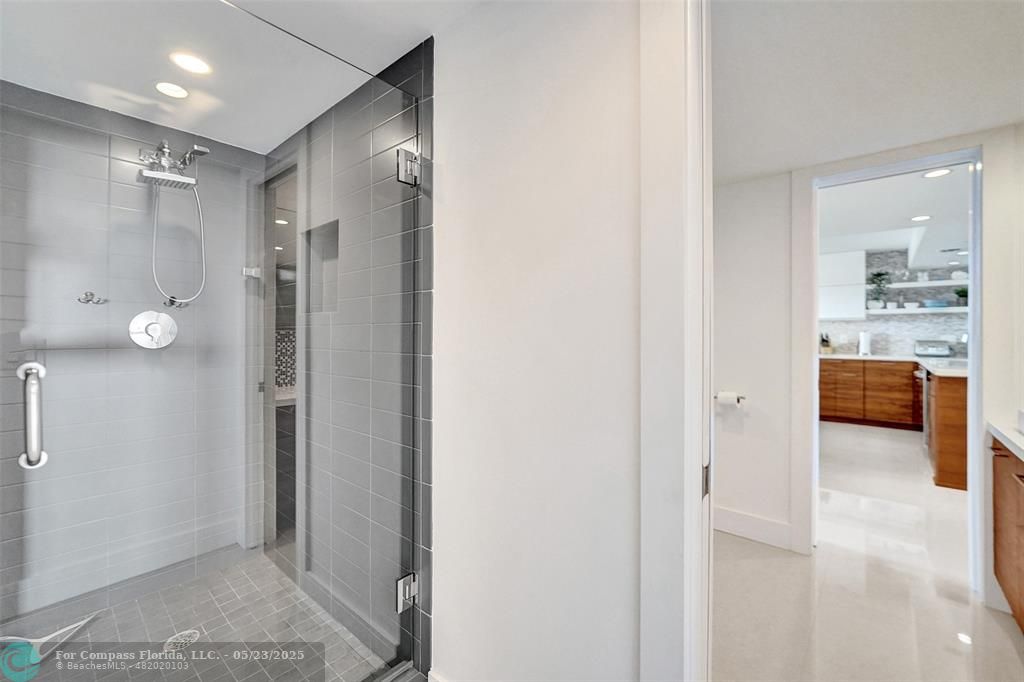 1523 East Hillsboro Boulevard, Unit 1031 Deerfield Beach, FL 33441 - Photo 55 of 78 a bathroom with a glass shower door a bathtub and a shower