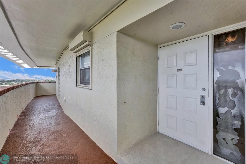1523 East Hillsboro Boulevard, Unit 1031 Deerfield Beach, FL 33441 - Photo 57 of 78 a view of a hallway with wooden floor and entryway