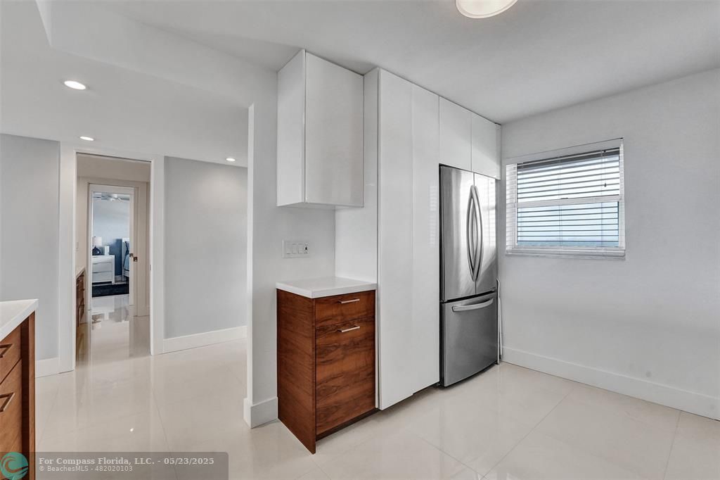 1523 East Hillsboro Boulevard, Unit 1031 Deerfield Beach, FL 33441 - Photo 6 of 78 a kitchen with stainless steel appliances granite countertop a refrigerator and a sink