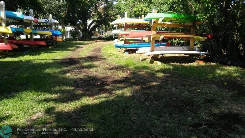 1523 East Hillsboro Boulevard, Unit 1031 Deerfield Beach, FL 33441 - Photo 77 of 78 a view of swimming pool with lawn chairs and a yard