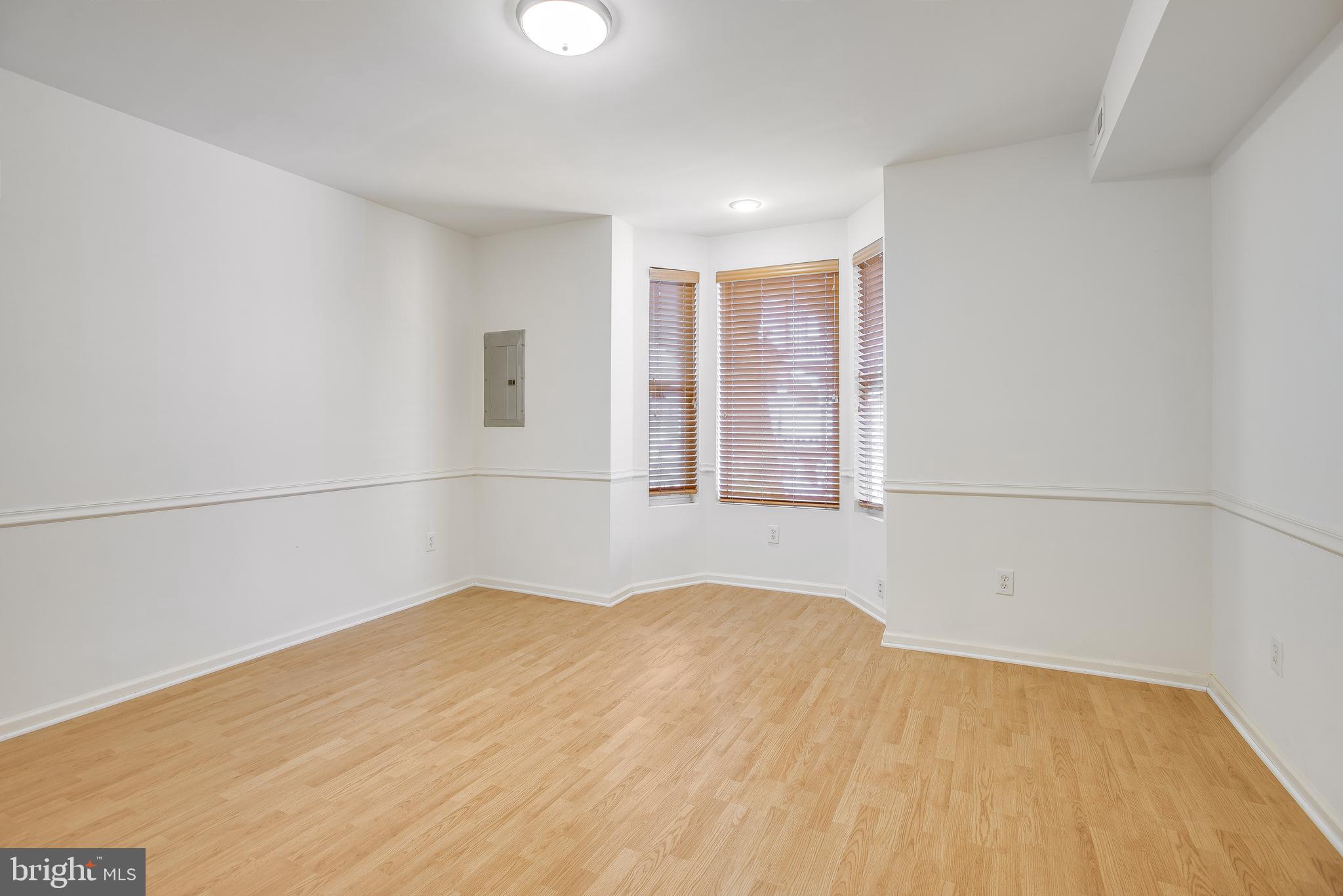 a view of empty room with wooden floor