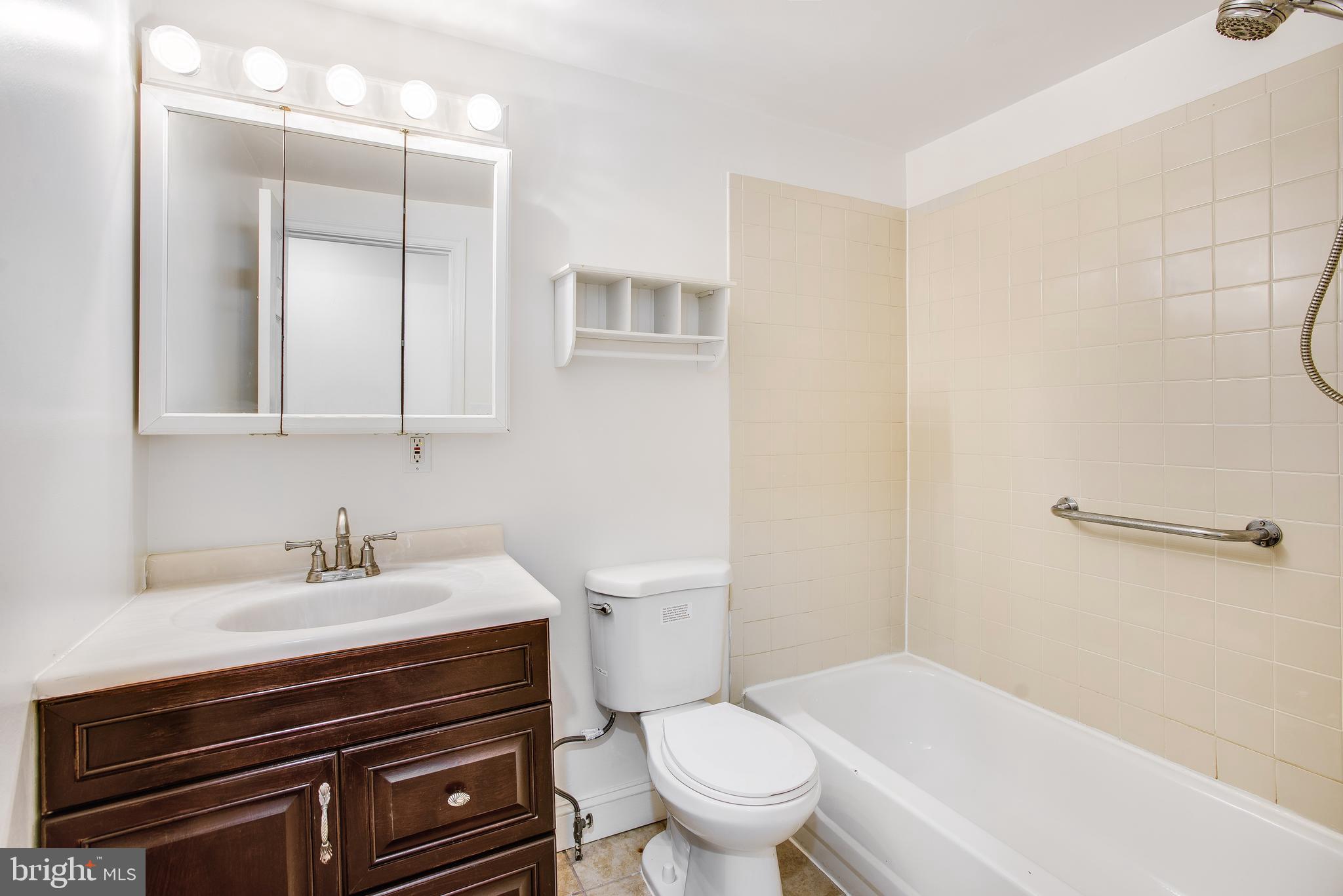 729 10th Street Northeast Washington, DC 20002 - Photo 13 of 20 a bathroom with a sink a toilet and shower