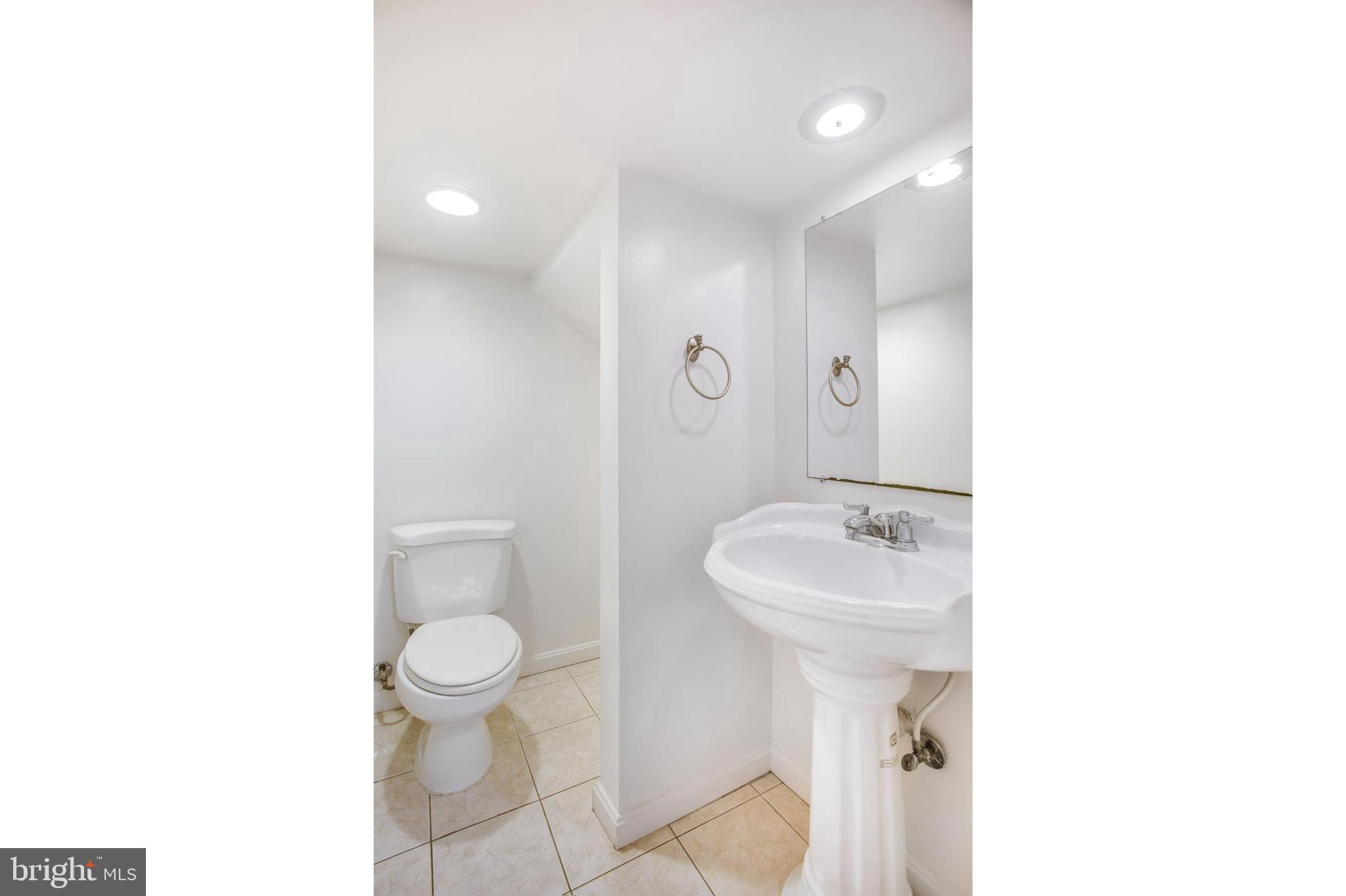 729 10th Street Northeast Washington, DC 20002 - Photo 4 of 20 a bathroom with a sink a toilet and a mirror