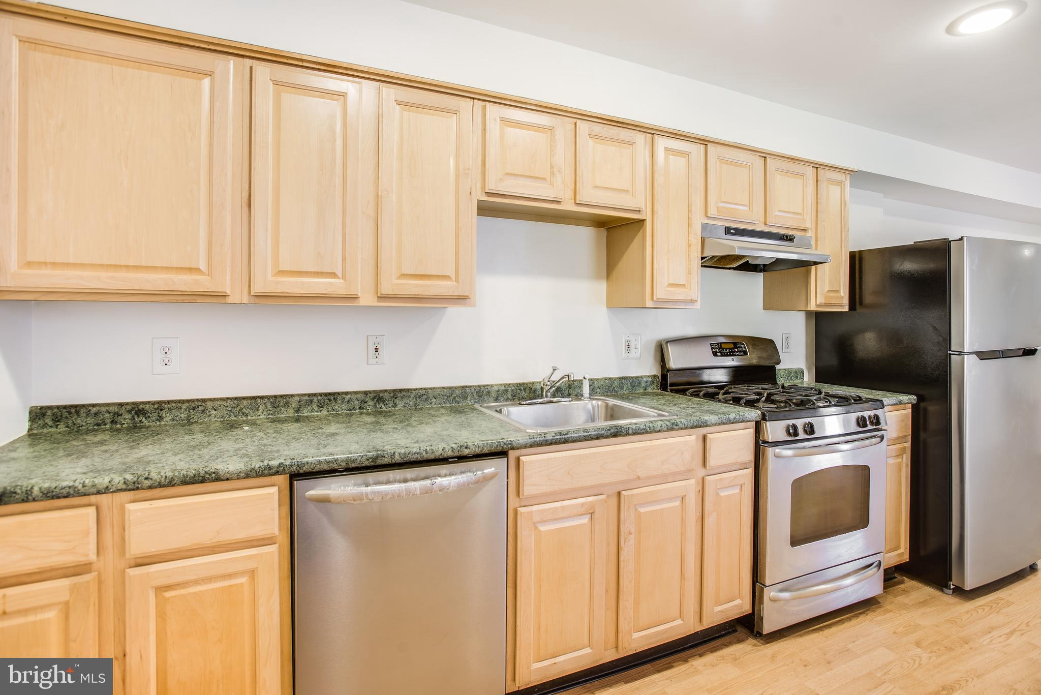 729 10th Street Northeast Washington, DC 20002 - Photo 7 of 20 a kitchen with stainless steel appliances granite countertop a stove a sink and a refrigerator