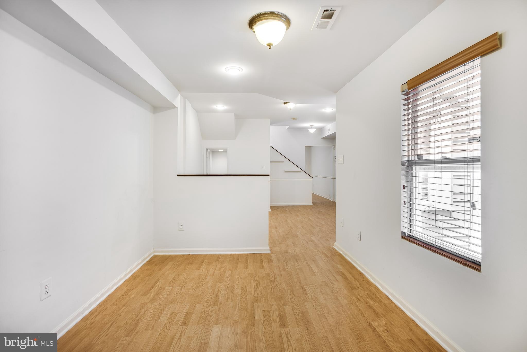 729 10th Street Northeast Washington, DC 20002 - Photo 9 of 20 a view of empty room with wooden floor and fan