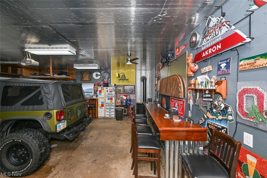 2274 Coon Road Akron, OH 44321 - Photo 34 of 44 *BAR AND WOOD STOVE FOR HEAT IN THE GARAGE W/ELECTRIC, CEILING FAN, LIGHTING, AUTOMATIC GARAGE OPENER -MAN CAVE! ~