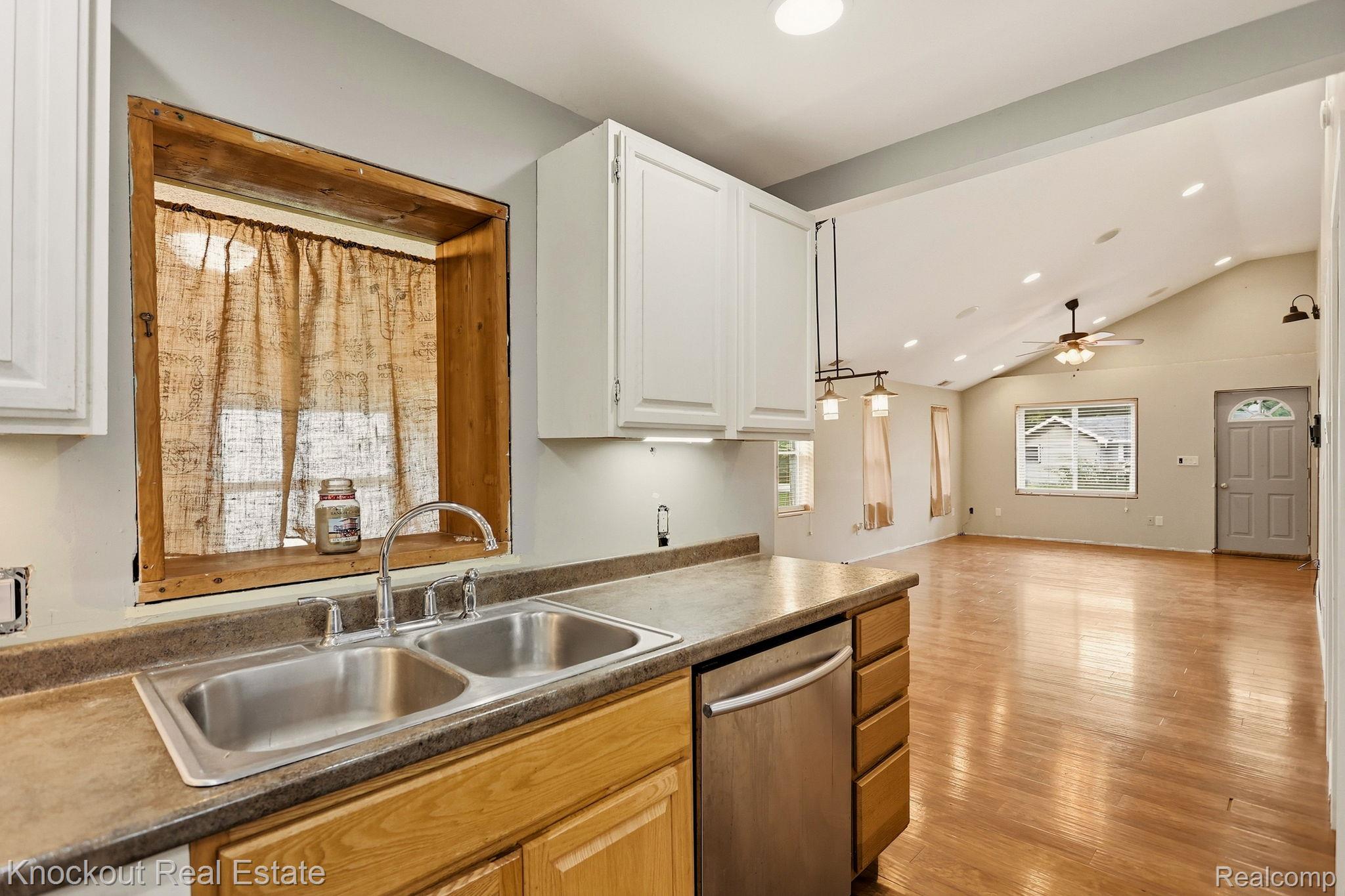 8811 Van Cleve Road Vassar, MI 48768 - Photo 15 of 39 Kitchen featuring a double basin stainless steel sink, wood-finish cabinetry, and stainless steel dishwasher