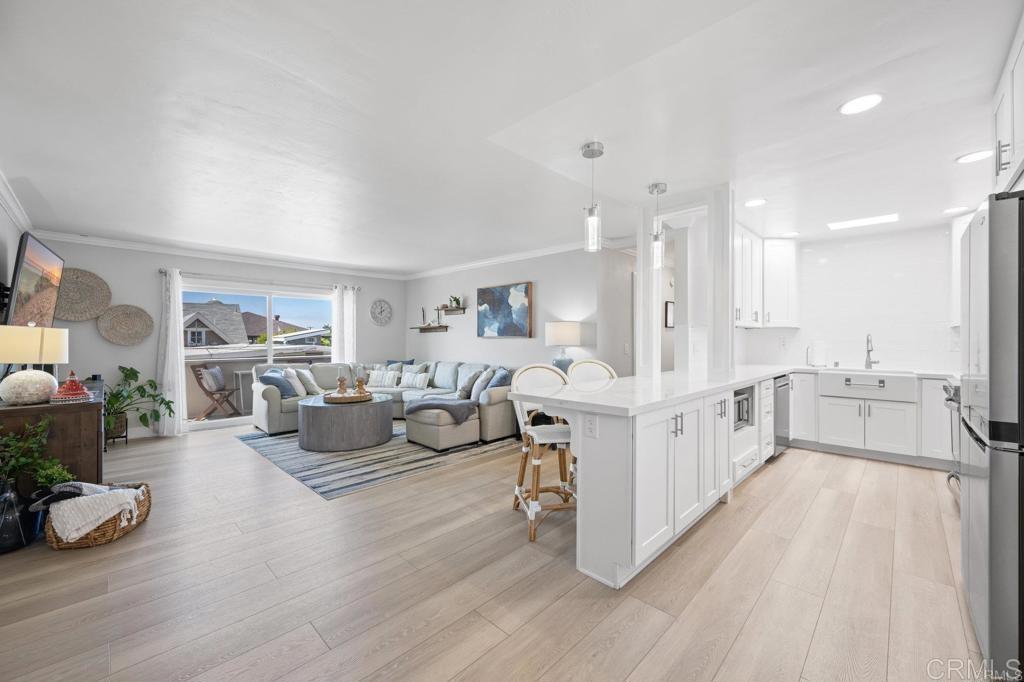 528 E Avenue Coronado, CA 92118 - Photo 2 of 19 a large white room with furniture and a wooden floor