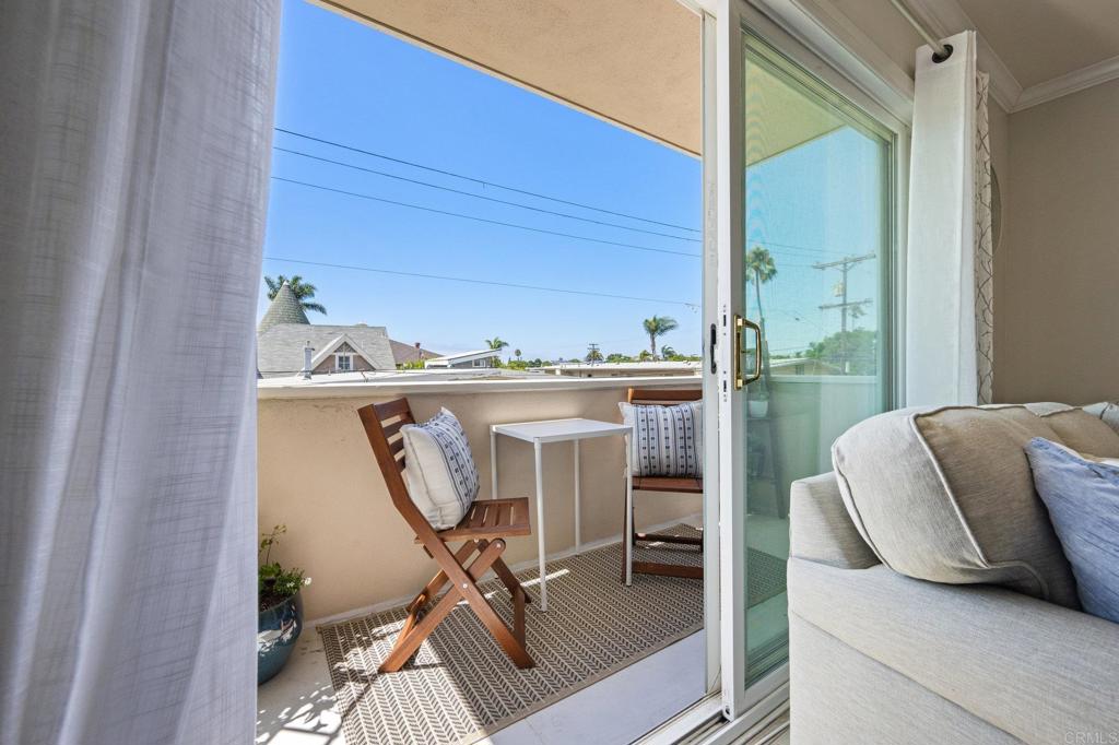 528 E Avenue Coronado, CA 92118 - Photo 8 of 19 a living room with furniture and a floor to ceiling window