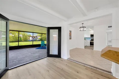 a view of hallway with wooden floor and door