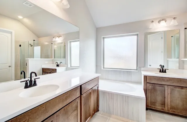 a bathroom with a tub sink and mirror