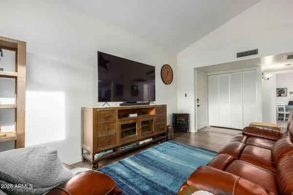 a living room with furniture a ceiling fan a rug and a window