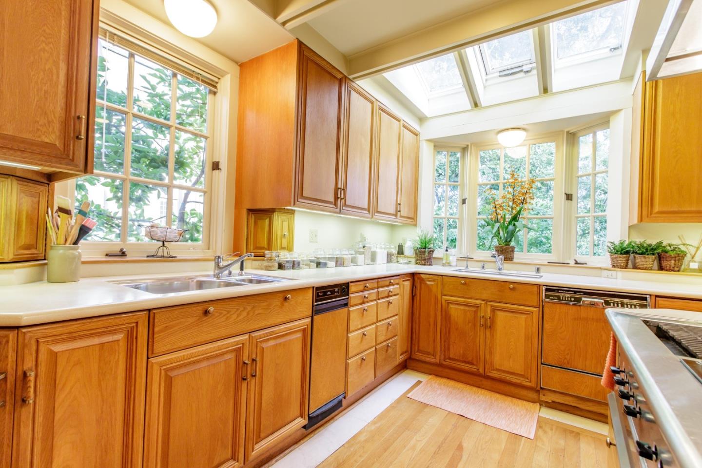 290 Richmond Road Hillsborough, CA 94010 - Photo 9 of 24 a kitchen with stainless steel appliances granite countertop white cabinets a sink and dishwasher next to a window