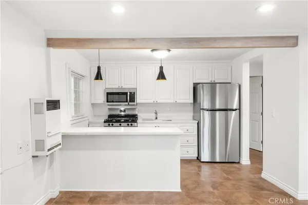 a kitchen with stainless steel appliances a refrigerator stove microwave and sink