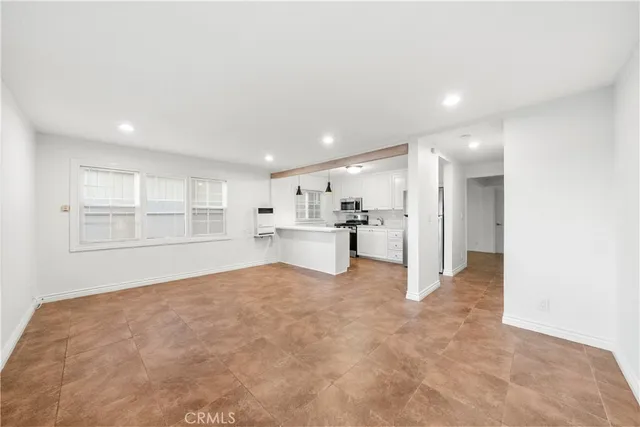 a view of kitchen with sink oven and window