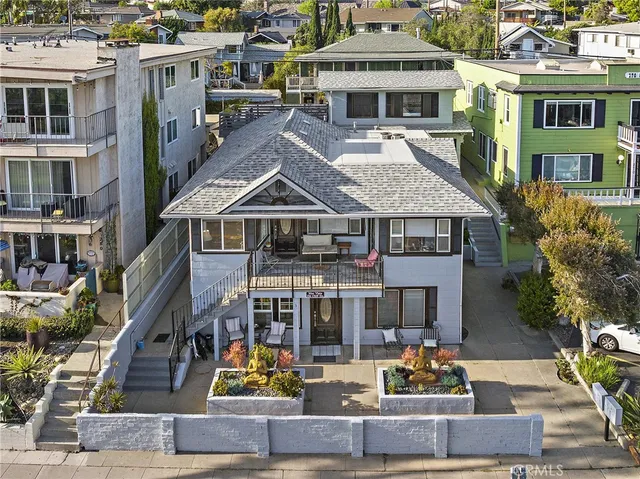 a large white kitchen with kitchen island a sink stainless steel appliances and cabinets