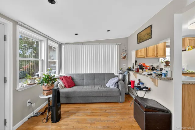 a kitchen that has a refrigerator a stove and a sink with wooden floor