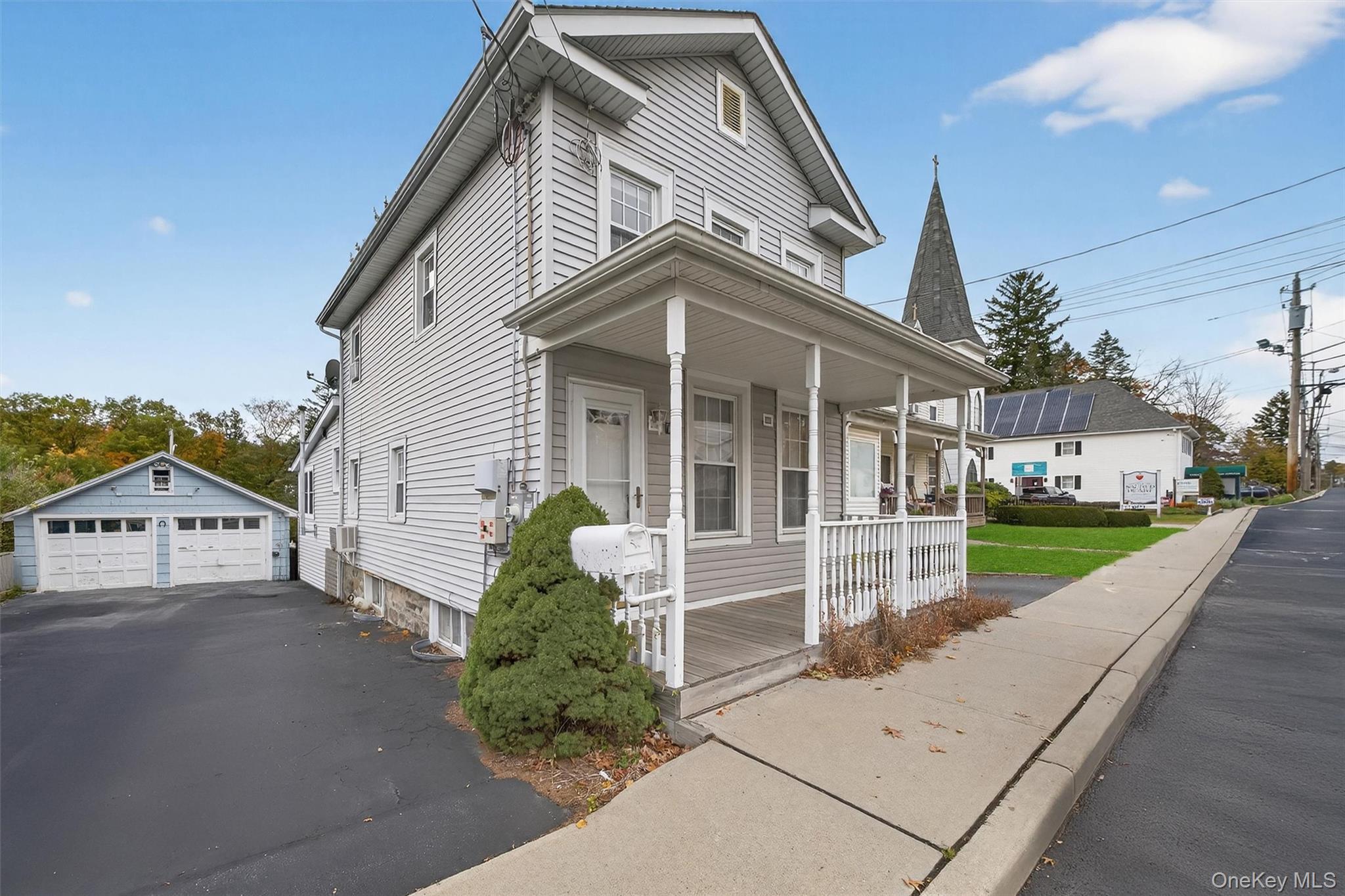 157 Stage Road Monroe, NY 10950 - Photo 2 of 23 a view of a white house with a small yard and potted plants