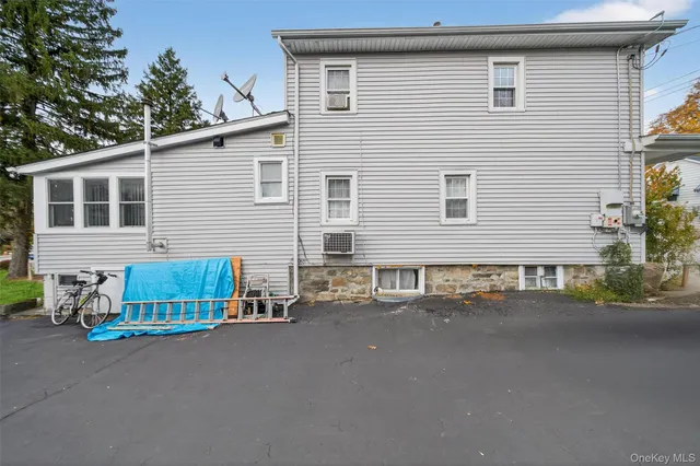 a view of a house with a small yard and sitting area