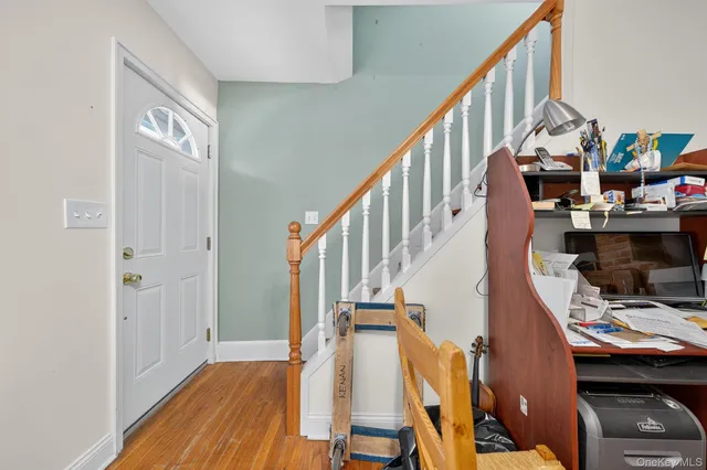 a view of a livingroom with wooden floor and stairs