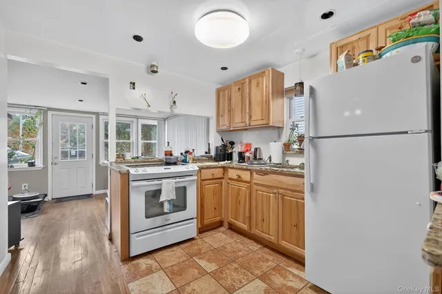 a kitchen with stainless steel appliances granite countertop a refrigerator sink and cabinets