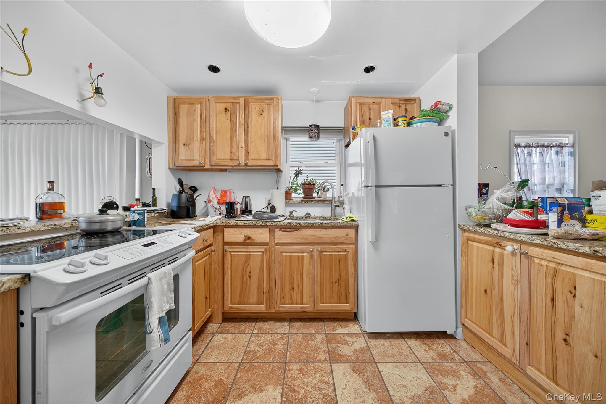 157 Stage Road Monroe, NY 10950 - Photo 9 of 23 a kitchen with a refrigerator sink and white cabinets