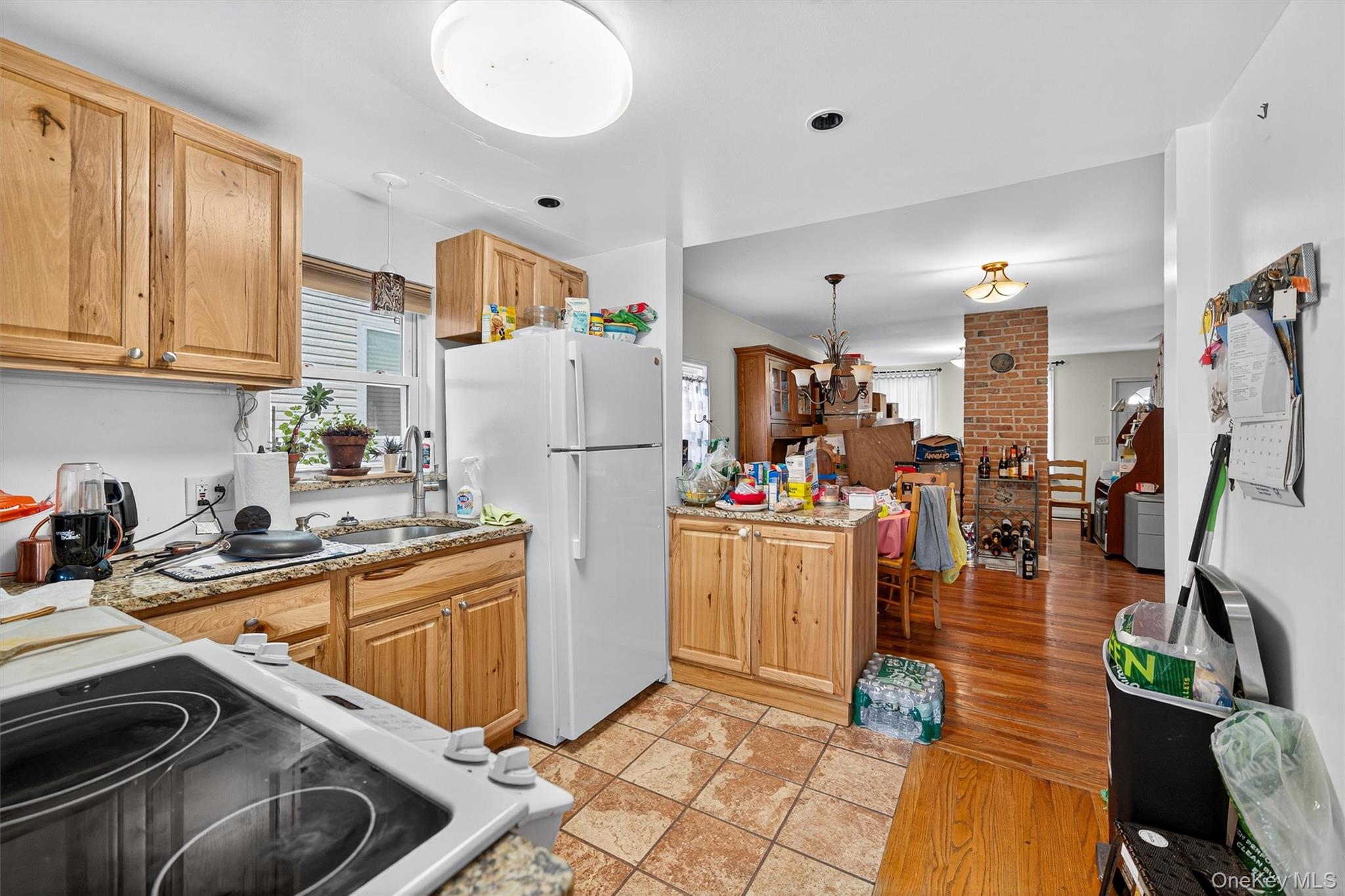 157 Stage Road Monroe, NY 10950 - Photo 23 of 23 a kitchen that has a refrigerator a stove and a sink with wooden floor