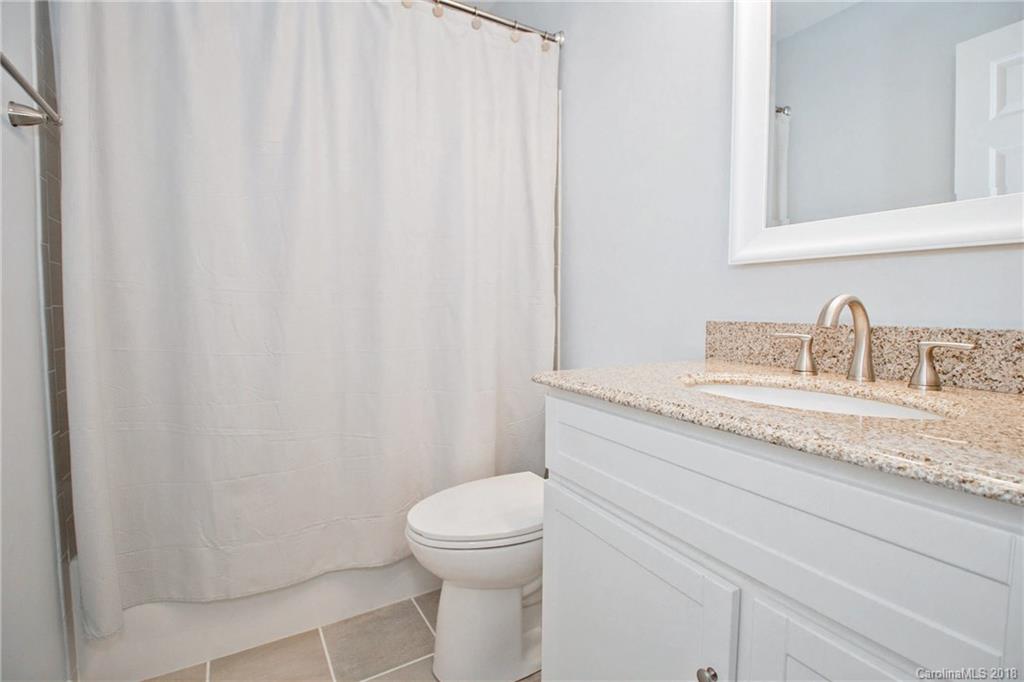 9331 Marshbrooke Road Charlotte, NC 28105 - Photo 17 of 20 a bathroom with a granite countertop sink and a toilet