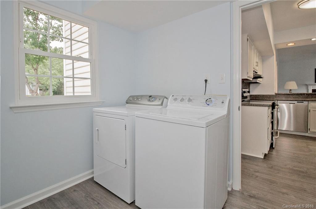 9331 Marshbrooke Road Charlotte, NC 28105 - Photo 18 of 20 a utility room with cabinets washer and dryer