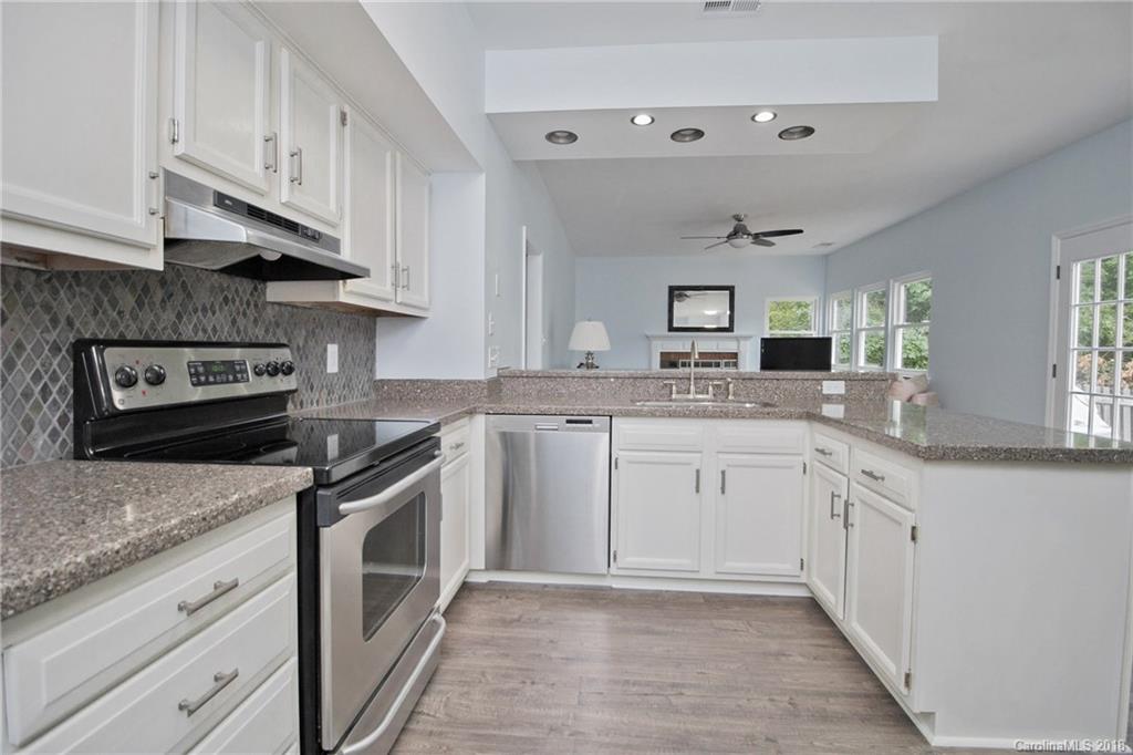9331 Marshbrooke Road Charlotte, NC 28105 - Photo 4 of 20 a kitchen with granite countertop a sink stainless steel appliances and cabinets