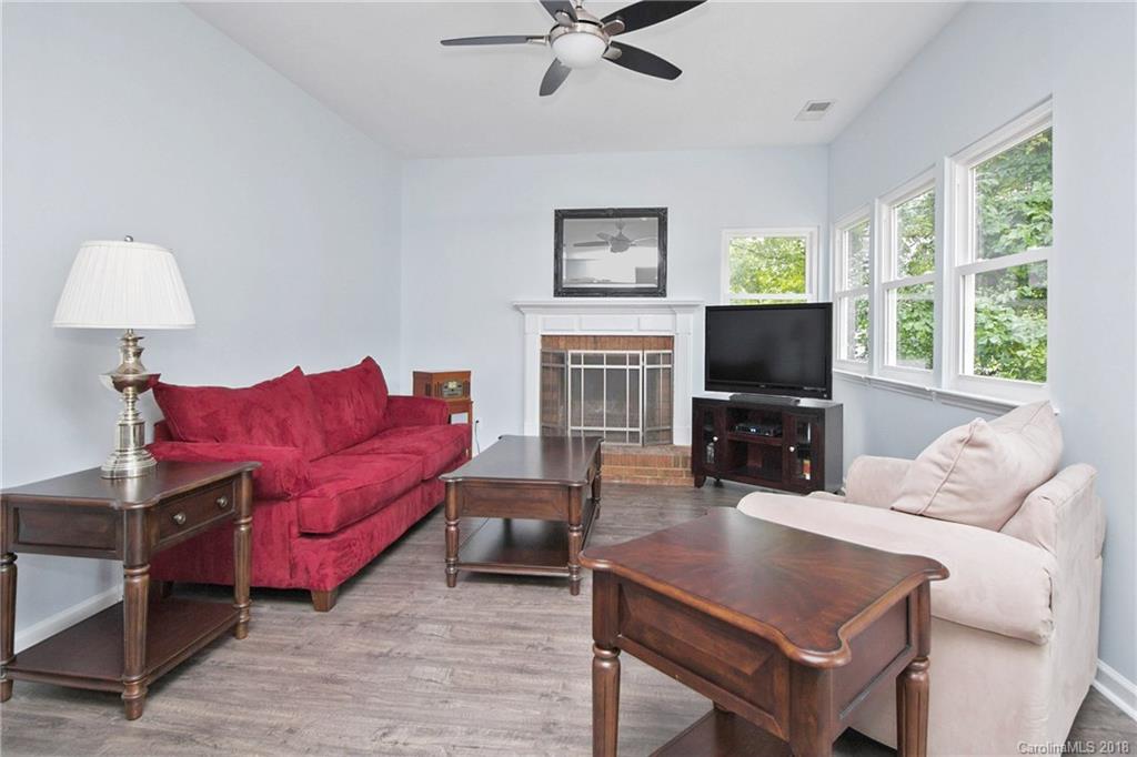 9331 Marshbrooke Road Charlotte, NC 28105 - Photo 5 of 20 a living room with furniture a large window and a flat screen tv