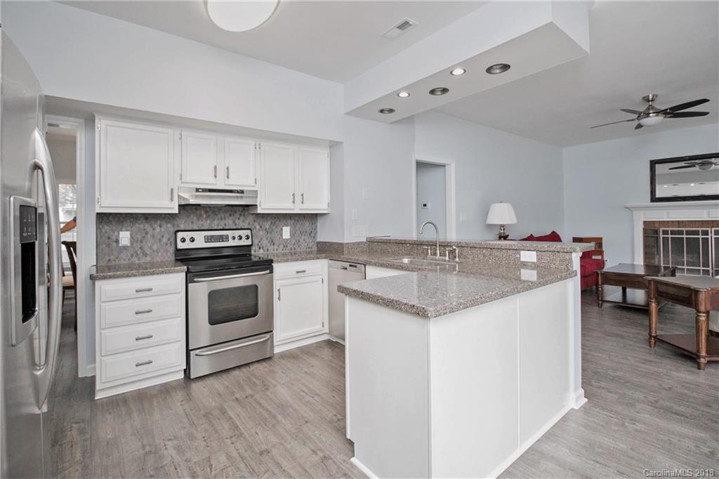 9331 Marshbrooke Road Charlotte, NC 28105 - Photo 6 of 20 a kitchen with a sink stove and cabinets