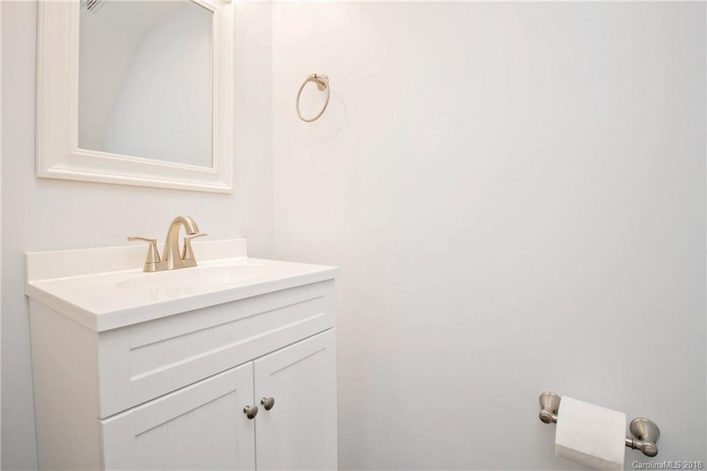 9331 Marshbrooke Road Charlotte, NC 28105 - Photo 8 of 20 a bathroom with a sink and mirror