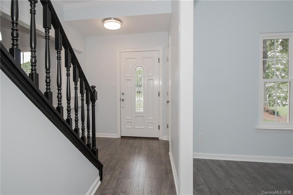 9331 Marshbrooke Road Charlotte, NC 28105 - Photo 9 of 20 a view of an entryway with wooden floor