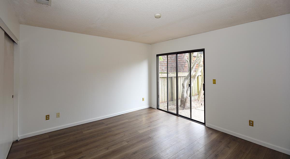 270 Beachview Avenue, Unit 14 Pacifica, CA 94044 - Photo 21 of 41 a view of an empty room with wooden floor and a window