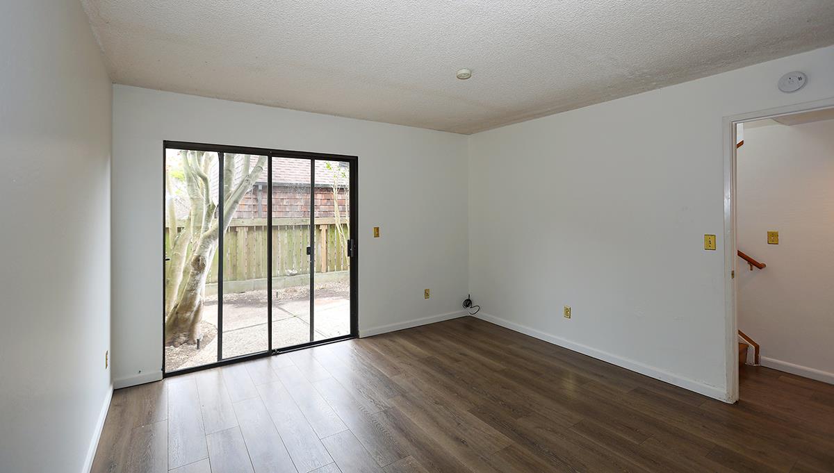 270 Beachview Avenue, Unit 14 Pacifica, CA 94044 - Photo 22 of 41 an empty room with wooden floor and windows