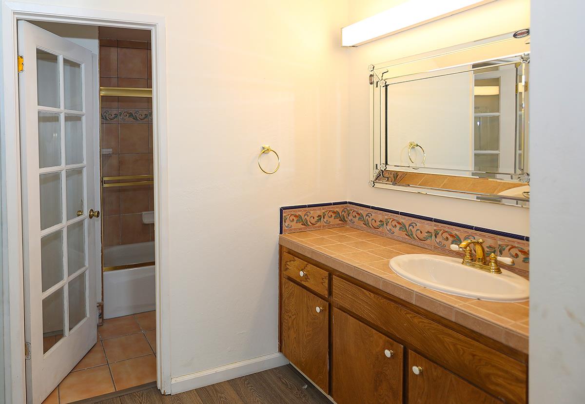 270 Beachview Avenue, Unit 14 Pacifica, CA 94044 - Photo 25 of 41 a bathroom with a granite countertop sink and a mirror