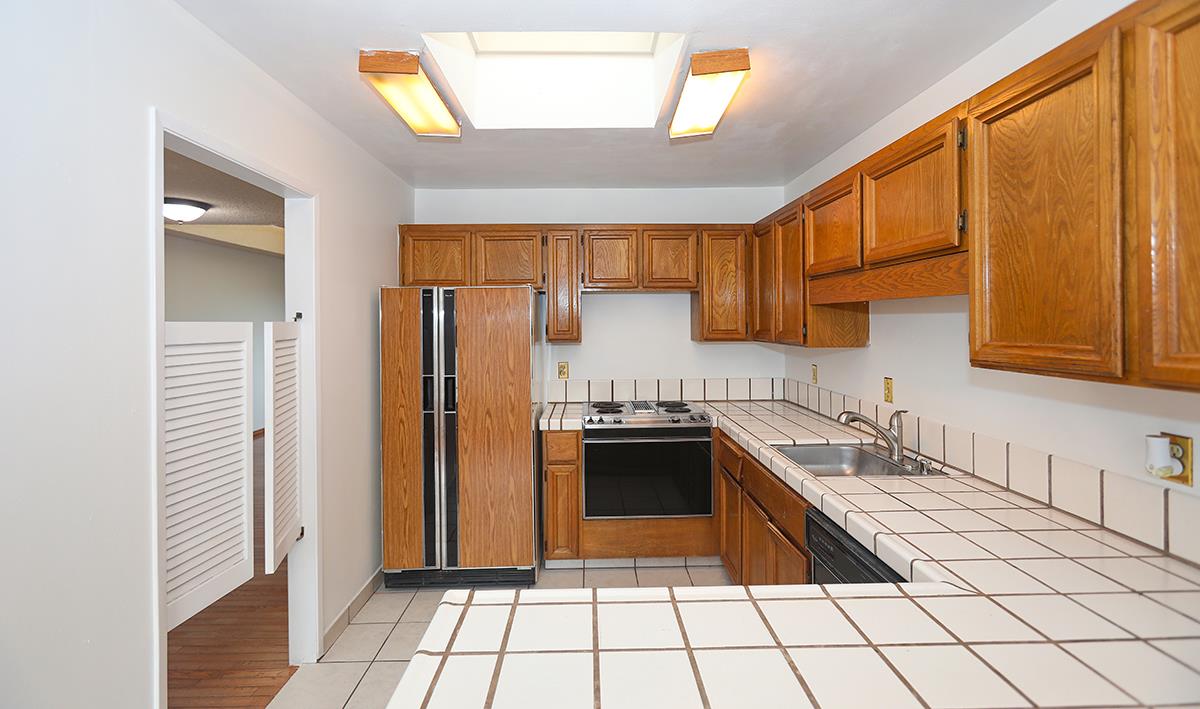 270 Beachview Avenue, Unit 14 Pacifica, CA 94044 - Photo 32 of 41 a kitchen with stainless steel appliances granite countertop a refrigerator and a sink