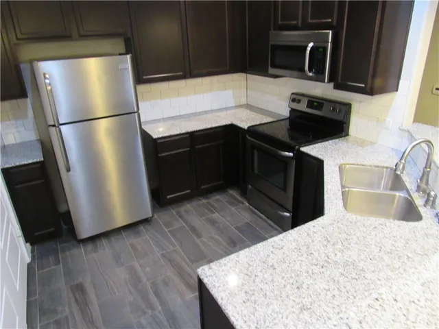 a kitchen with sink and cabinets
