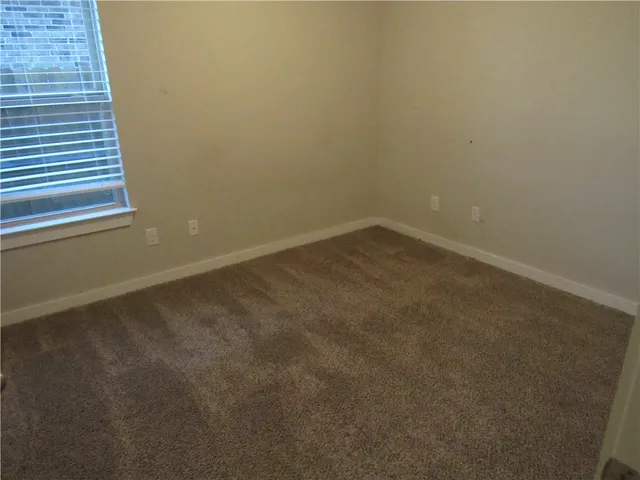 a bathroom with a toilet and shower