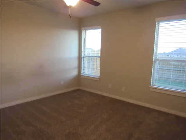 an empty room with a empty space and windows