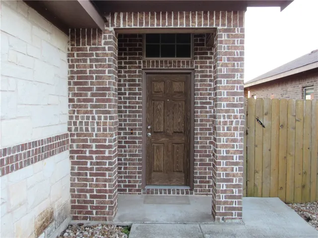 a view of backyard with wooden fence