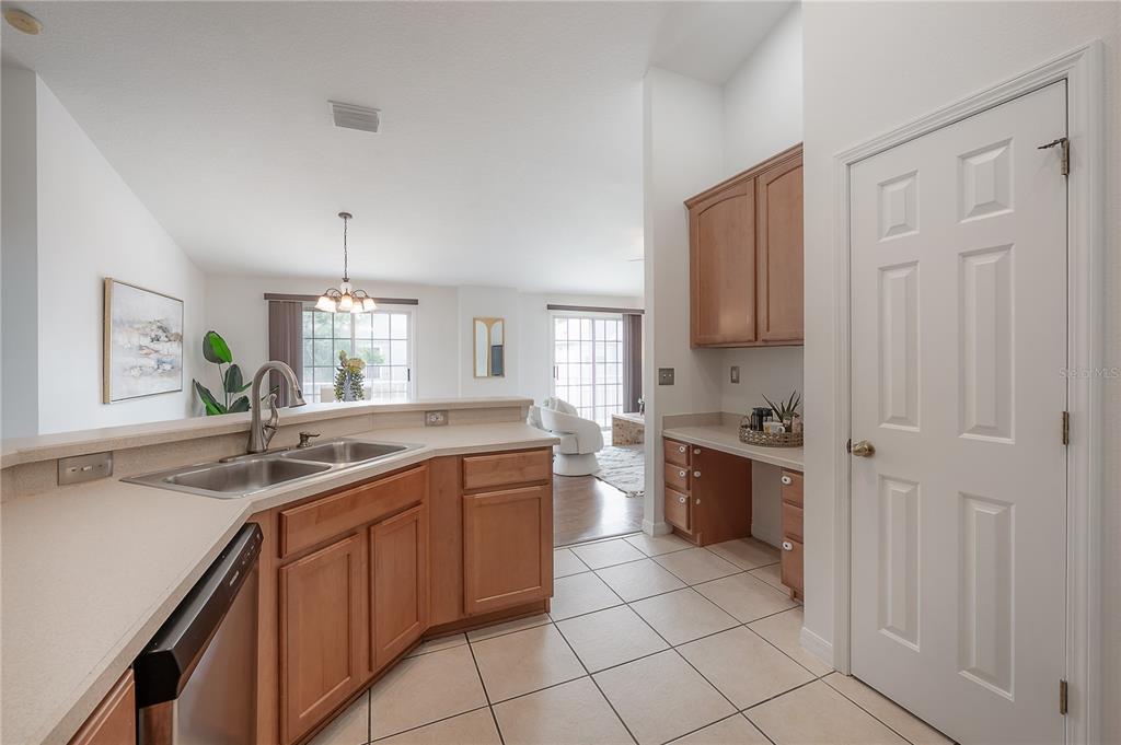 27834 Pleasure Ride Loop Wesley Chapel, FL 33544 - Photo 11 of 25 a kitchen with a sink stove and cabinets