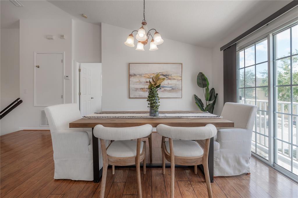 27834 Pleasure Ride Loop Wesley Chapel, FL 33544 - Photo 12 of 25 a view of a dining room with furniture and wooden floor