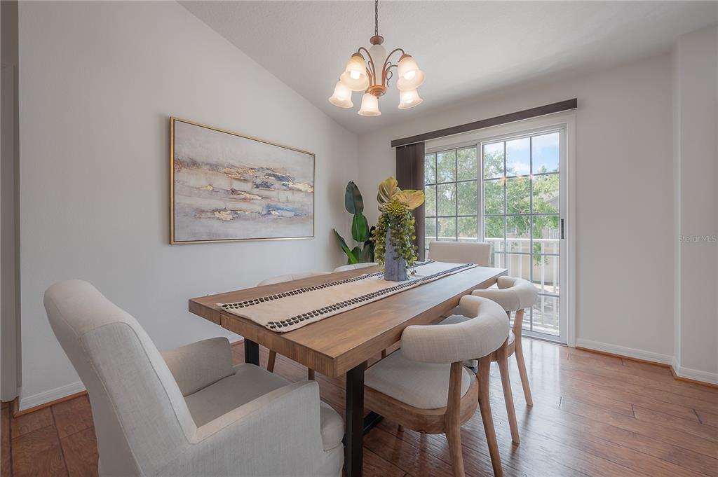 27834 Pleasure Ride Loop Wesley Chapel, FL 33544 - Photo 13 of 25 a view of a dining room with furniture window and wooden floor