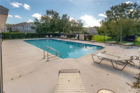 a view of a swimming pool with a lounge chairs