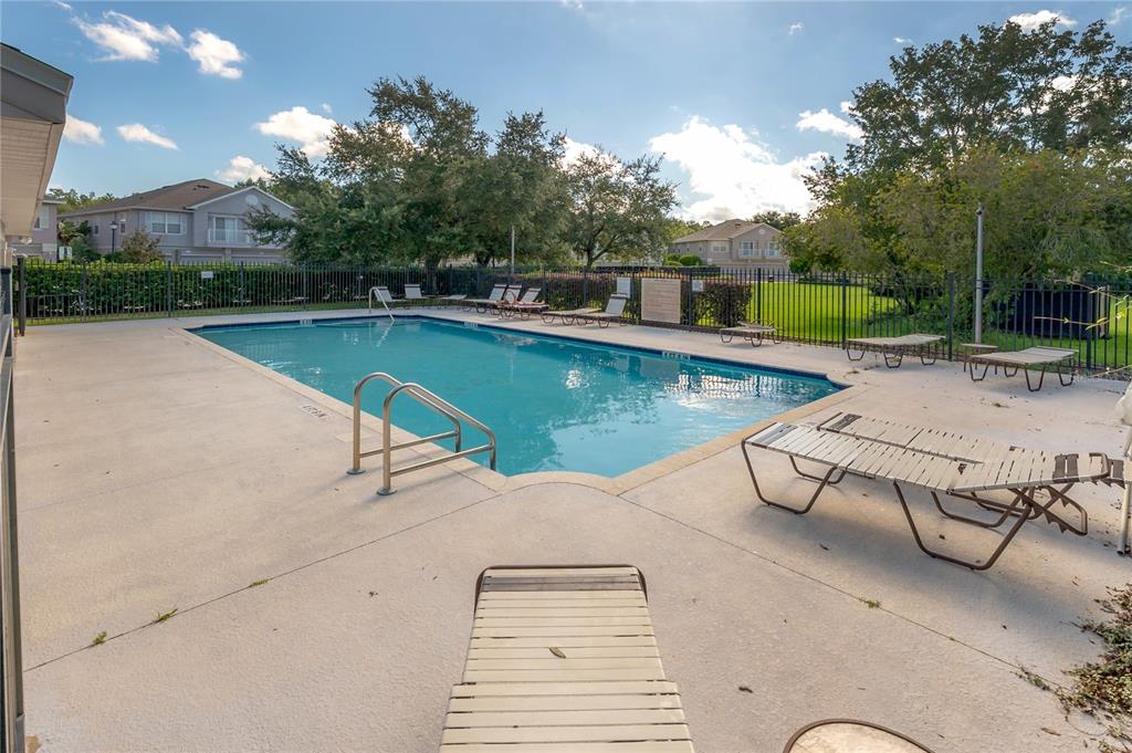 27834 Pleasure Ride Loop Wesley Chapel, FL 33544 - Photo 25 of 25 a view of a swimming pool with a lounge chairs