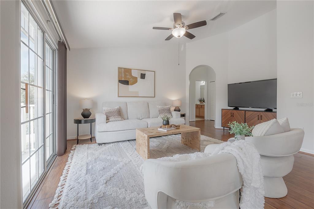 27834 Pleasure Ride Loop Wesley Chapel, FL 33544 - Photo 5 of 25 a living room with furniture a ceiling fan and a flat screen tv